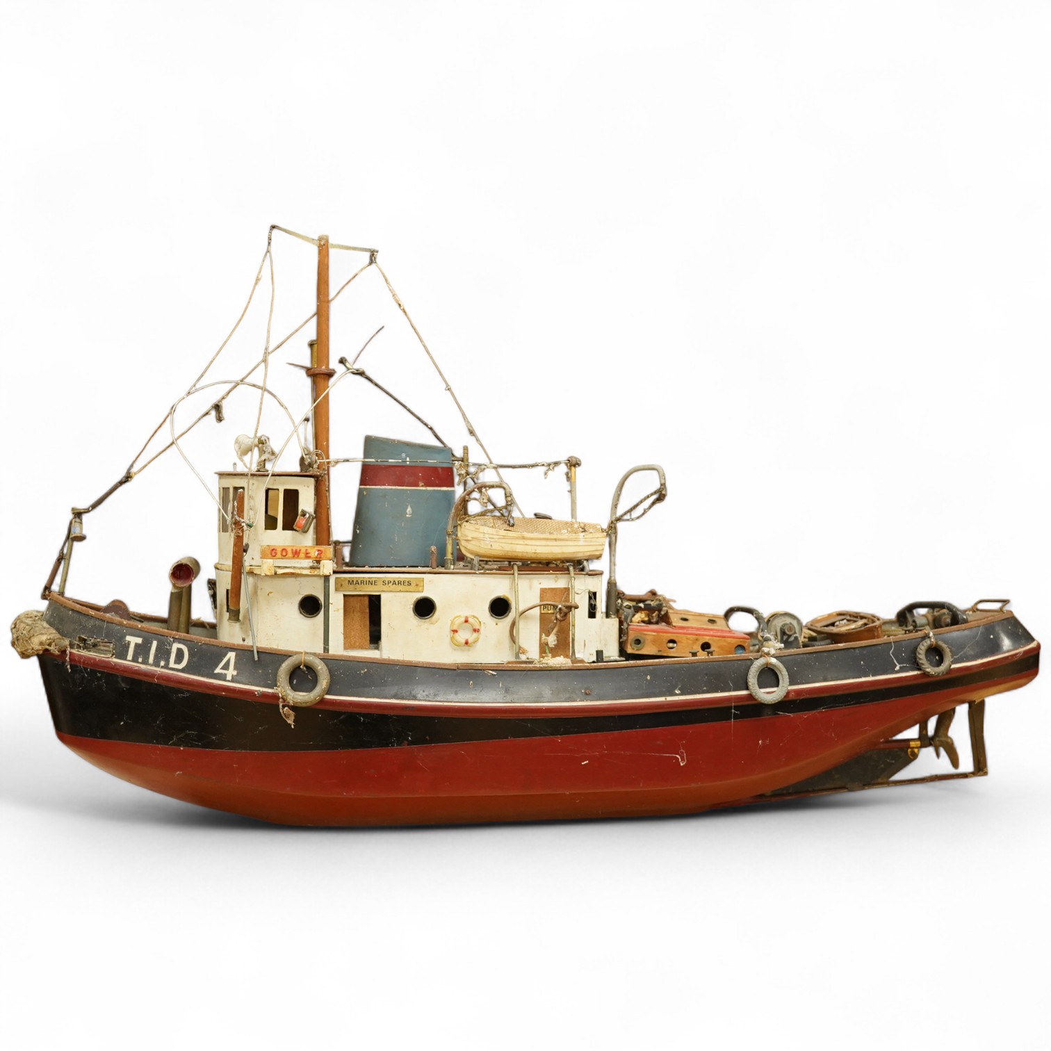A scale model of a tug boat ‘T.I.D 4’, a well detailed model with the remains of internal wiring and electric motor for use as a pond yacht, length of hull approx 92cm. Condition - poor to fair, now in need of some resto